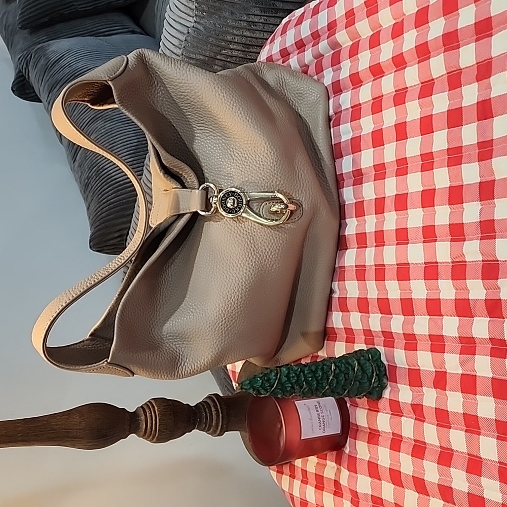 Dooney & Bourke tan colored women's snap clip bag. Excellent used condition.